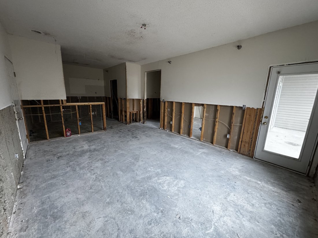 Commercial strip out demolition in Columbia, MO with interior partitions taken back to the studs and the flooring removed down to bare slab