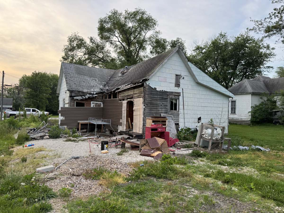 Older frame house partway through demolition on an Atlas job, the kind of teardown we handle for demolition in Columbia, MO