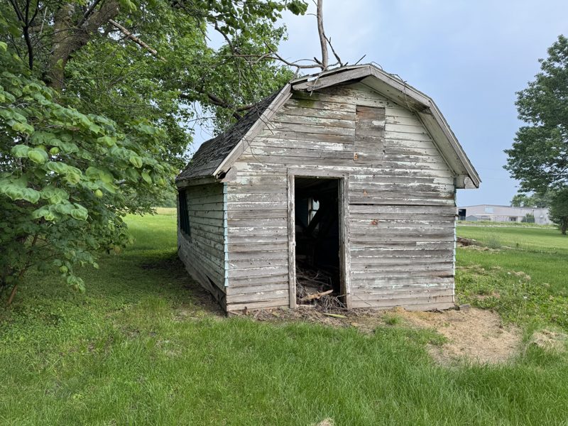 Weathered wooden outbuilding waiting for demolition on a Mid-Missouri property
