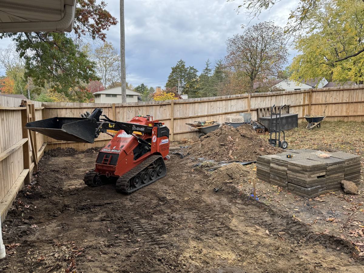 Forestry mulching and land clearing in Columbia, MO: an Atlas compact track loader clearing brush along a fence line on a Mid-Missouri property