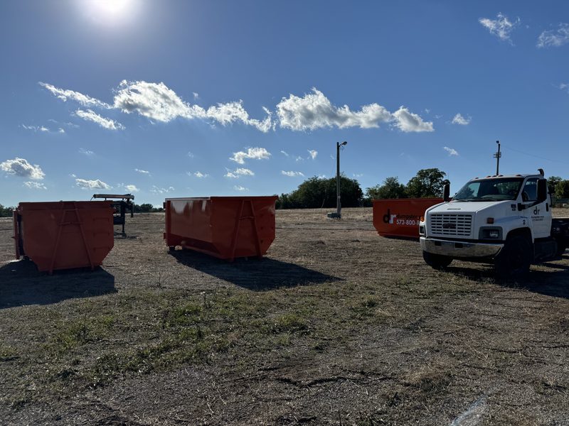 Graded lot after demolition in a Mid-Missouri neighborhood, with the site backfilled, shaped to drain, and ready for the next build