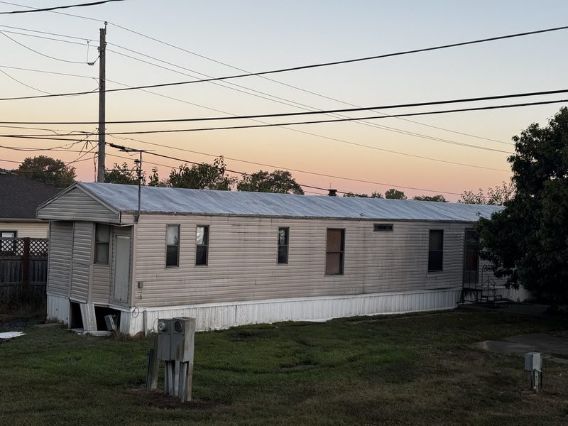 Electric meter pedestals and an overhead service drop at a Mid-Missouri mobile home scheduled for demolition, before the utility pulls the meters