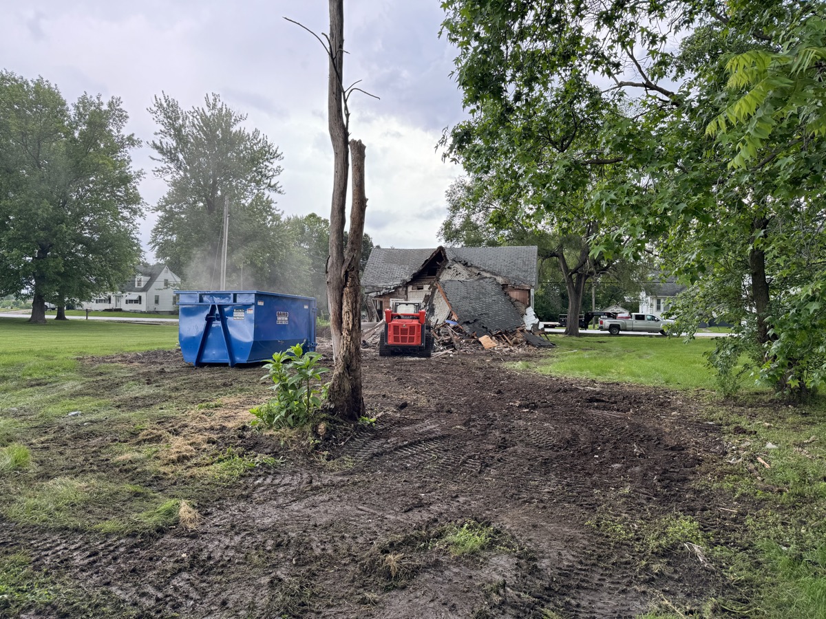 How long does demolition take in Missouri shown with an Atlas excavator mid-teardown of a house in Columbia MO